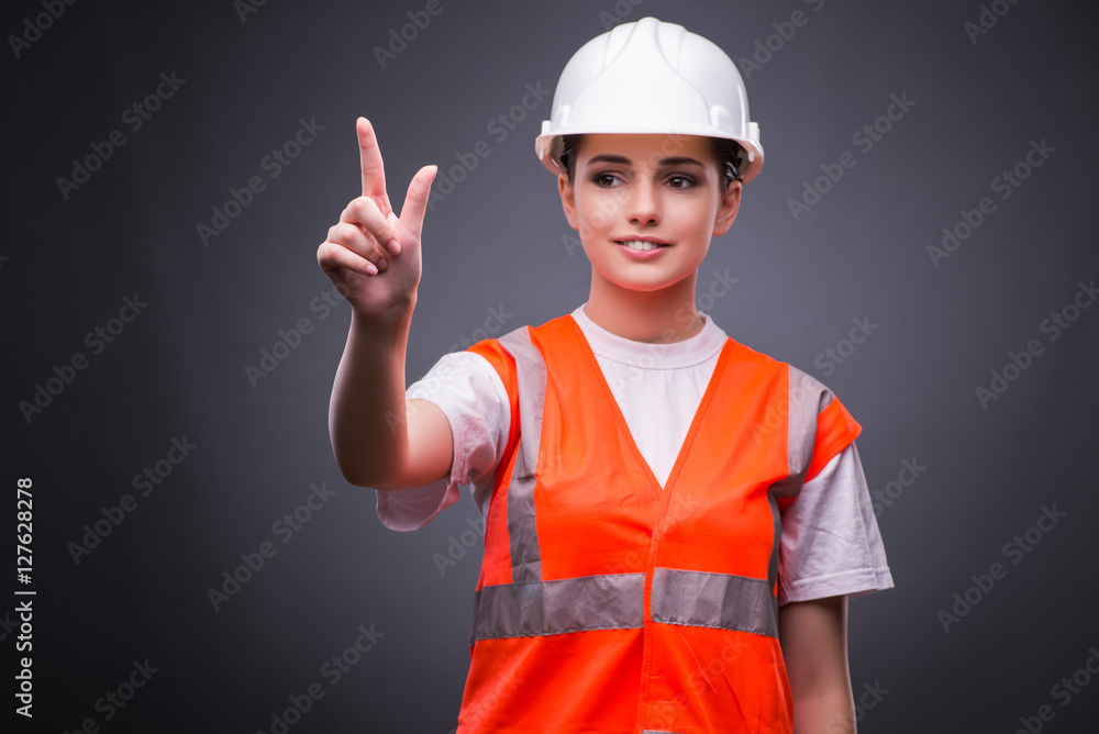 Cute construction worker pressing virtual buttons Cute construction worker pressing virtual buttons