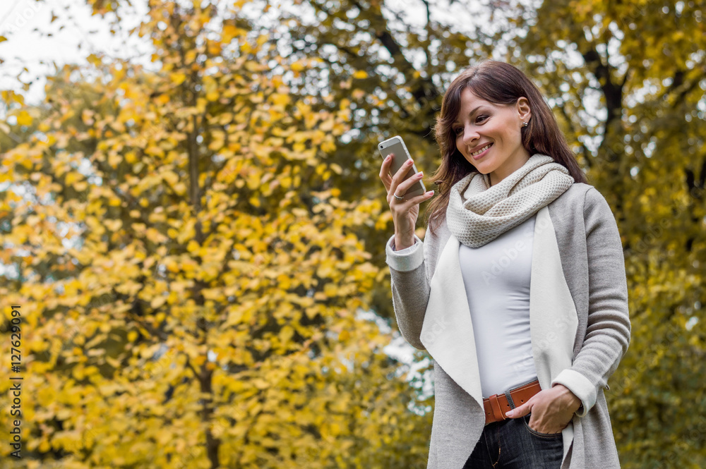 Portrait of happy smiling woman holding cellphone in hands, usin Portrait of happy smiling woman holding cellphone in hands, usin
