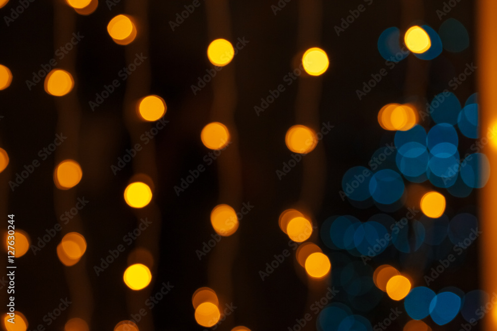 Closeup of Christmas-tree background in the living room of the house with glowing stars on the wall