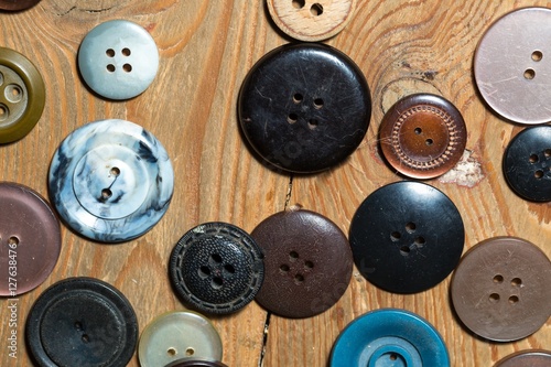 Buttons lying on old wooden floor.