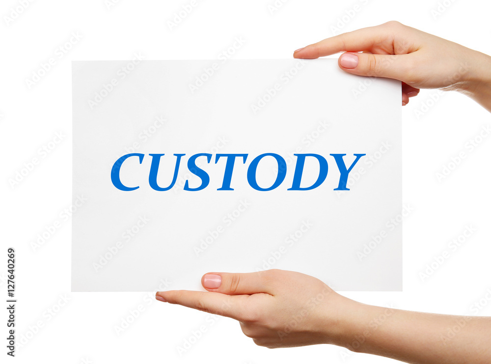 Female hands holding paper with word CUSTODY on white background Female hands holding paper with word CUSTODY on white background