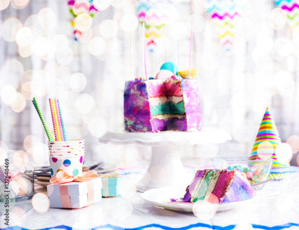 Sliced colorful cake on festive table Sliced colorful cake on festive table