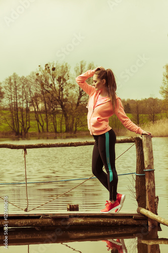  Young sports woman taking break after a run.
