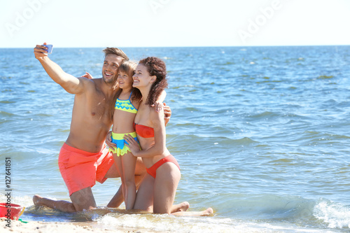 Cheerful family taking self...