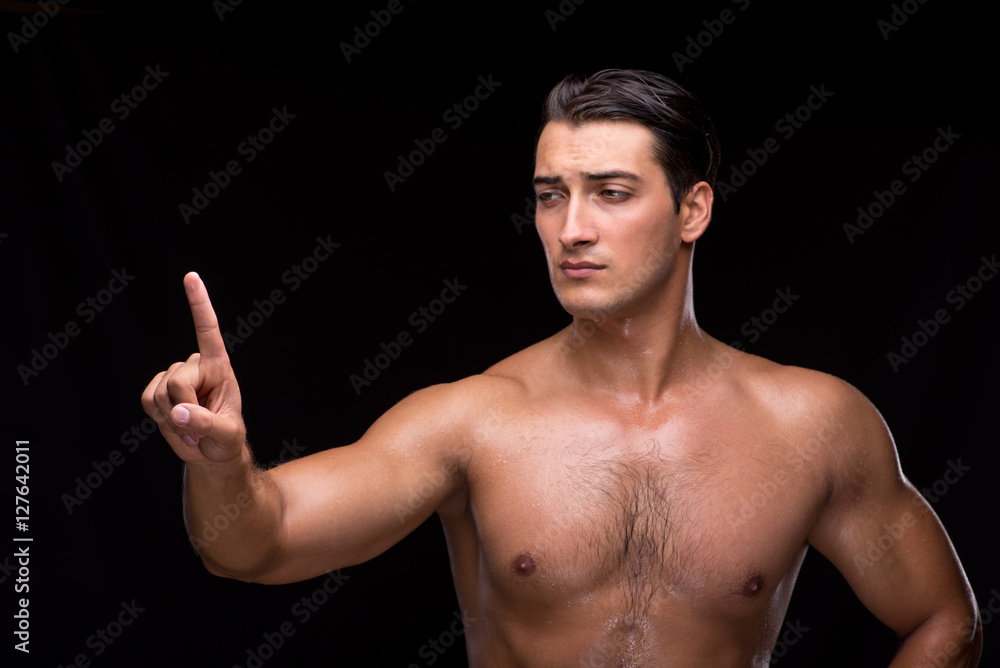 Ripped muscular man pressing virtual buttons Ripped muscular man pressing virtual buttons