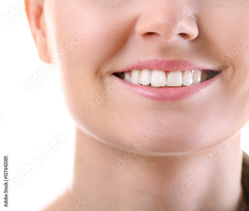 Young woman smiling on white background