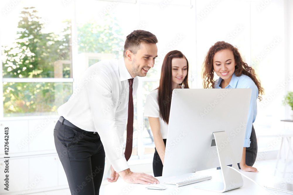 Business training concept. Colleagues looking at computer monitor in office Business training concept. Colleagues looking at computer monitor in office