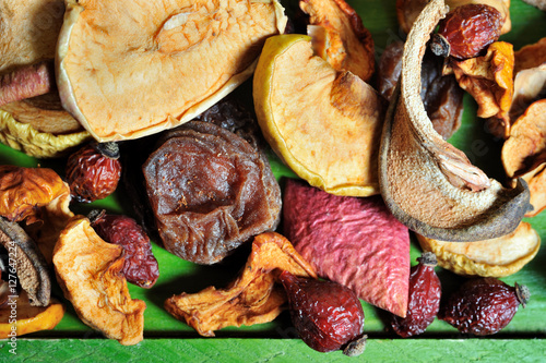 Dried fruits on wooden green board