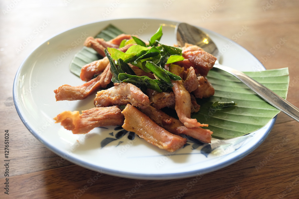 delicious fried pork on white dish. Thai food