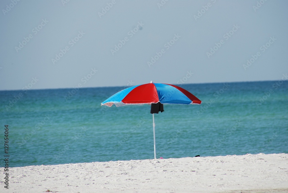 Bright Sun Umbrella Set-up on Beautiful Sandy Beach with Blue Ocean