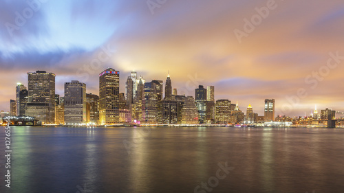Downtown Manhattan Skyline Lights at Dusk with Clouds © Philippe