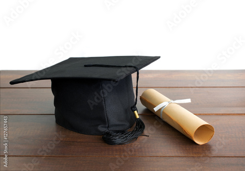 graduation cap, hat with degree paper on wood table Empty ready photo