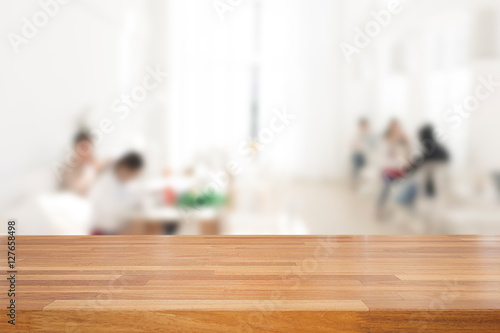 Empty wooden table and blurred people in cafe background, produc