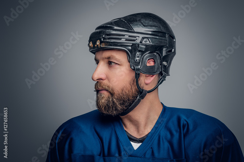 Photography Close up portrait of ice-hockey player in safety helmet.