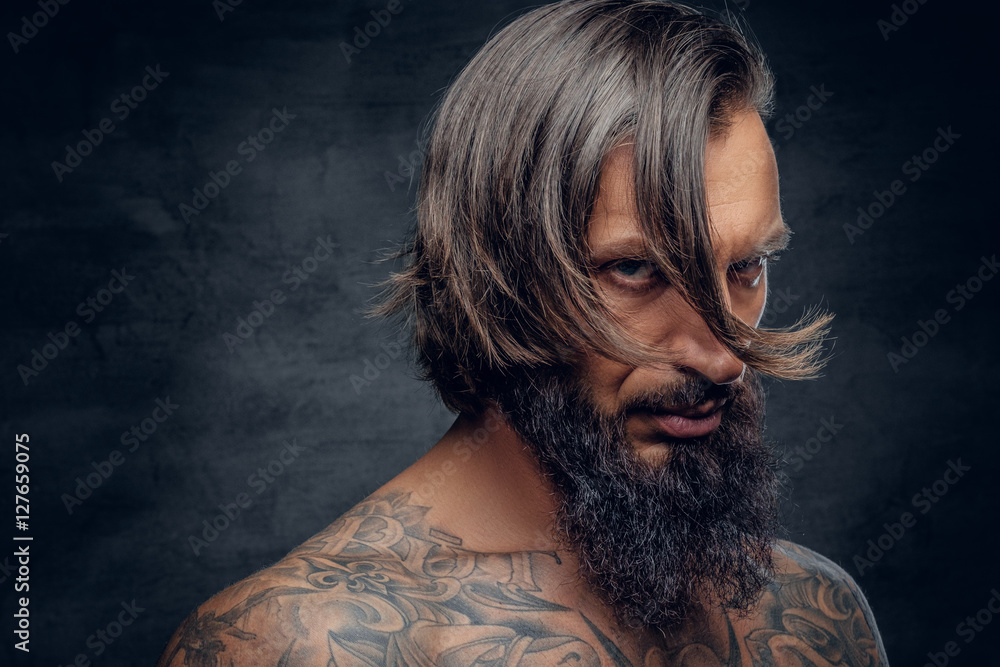 © Fxquadro - Bearded male with long hair and tattooed chest. © Fxquadro - Bearded male with long hair and tattooed chest.