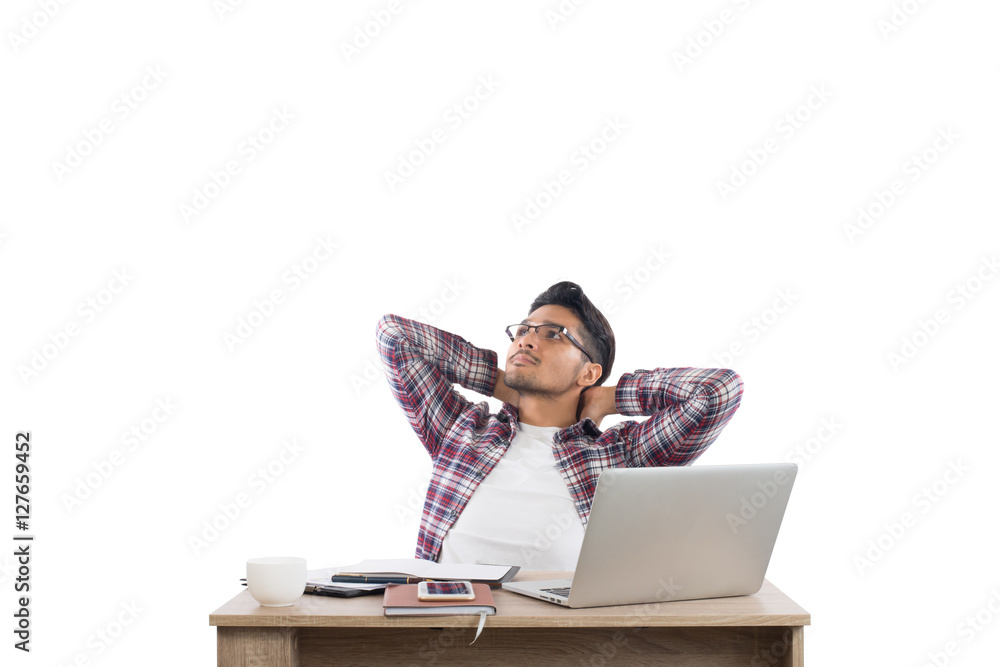 Young businessman relaxing at workplace thoughtful with work iso Young businessman relaxing at workplace thoughtful with work iso