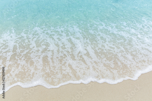 Close up blue sea water waves on white sand beach,Beautiful blue ocean beach close up shot, Clean beach with blue sea in Thailand
