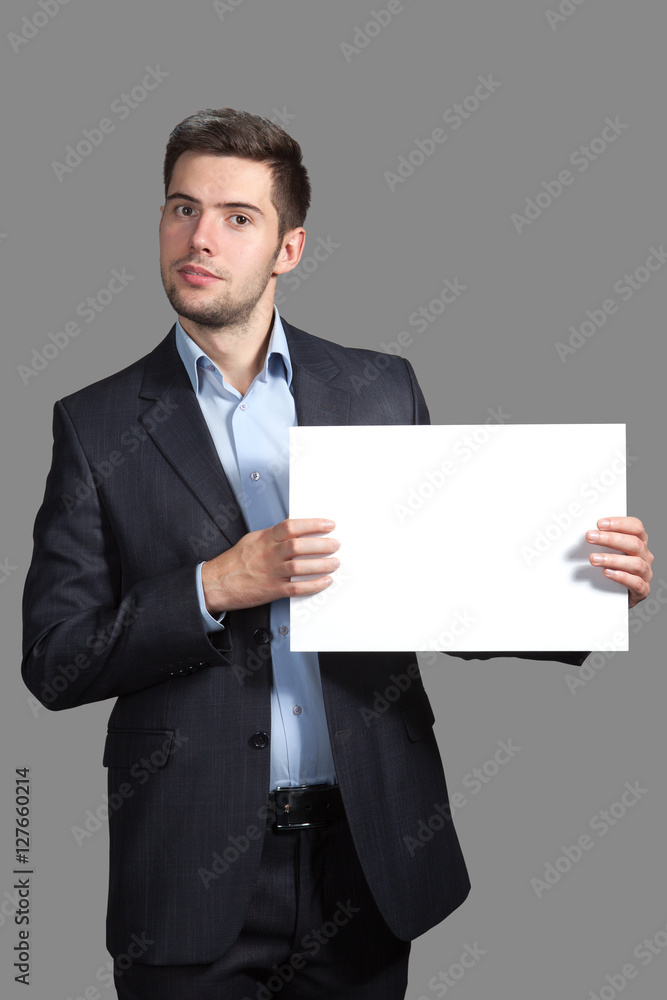 Portrait of a Man with a sign on a gray background Portrait of a Man with a sign on a gray background