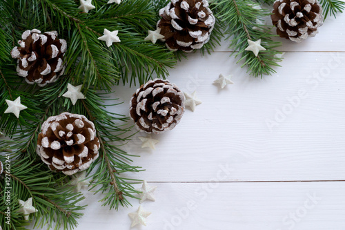 Christmas wooden background with fir branches and cones