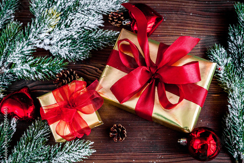 gifts boxes with fir branches on wooden background top view