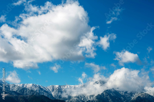Snow on the top of Mountain with cloudy blue sky for copy space, Winter season Sky and Scenery