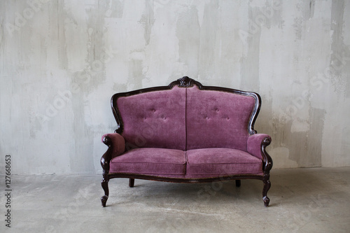 Purple vintage sofa on a gray background