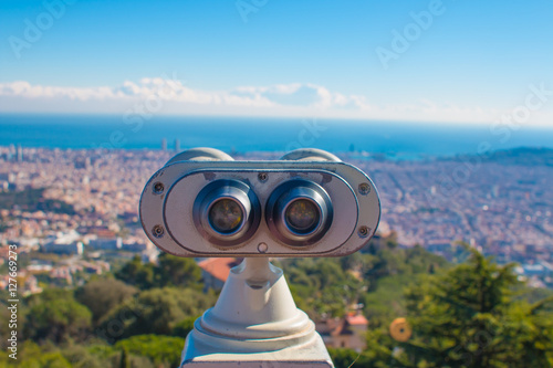 Coin operated binoculars and panoramic view of the city