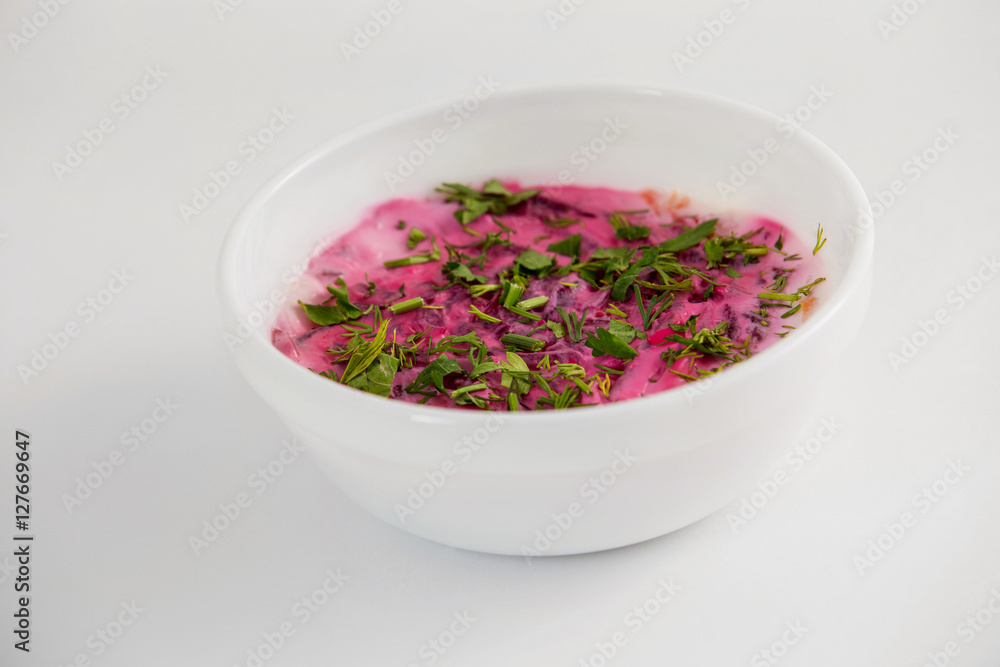 Bowl of traditional Russian salad herring under coat at isolated Bowl of traditional Russian salad herring under coat at isolated