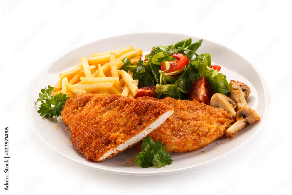 Fried pork chop, French fries and vegetables 