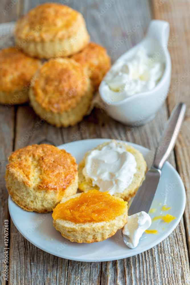 Scones with orange jam and whipped cream for breakfast. Scones with orange jam and whipped cream for breakfast.