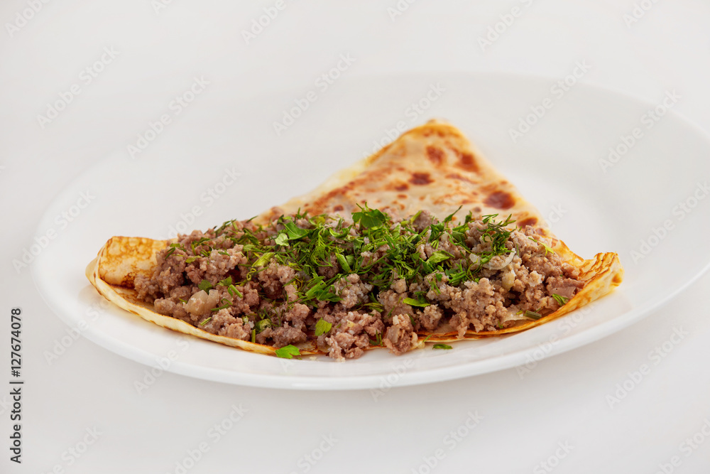 Traditional Russian meal blin stuffed with beef forcemeat Traditional Russian meal blin stuffed with beef forcemeat