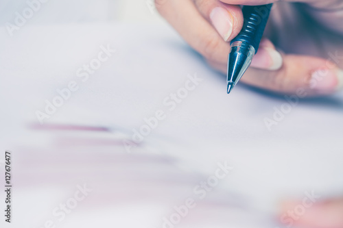 Business women hands working writing notebook on wooden desk, li photo