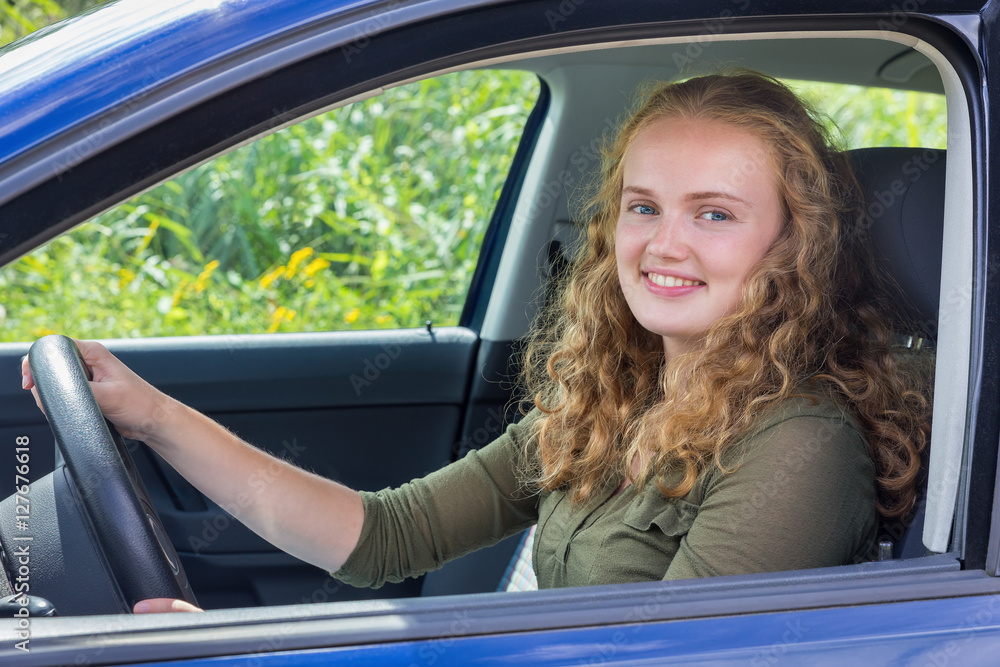 Young caucasian woman driving car