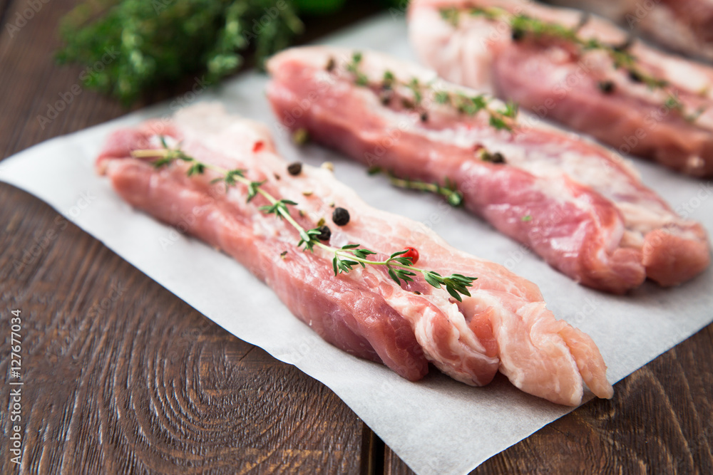 Raw meat. Pork ribs with herbs and spices Raw meat. Pork ribs with herbs and spices