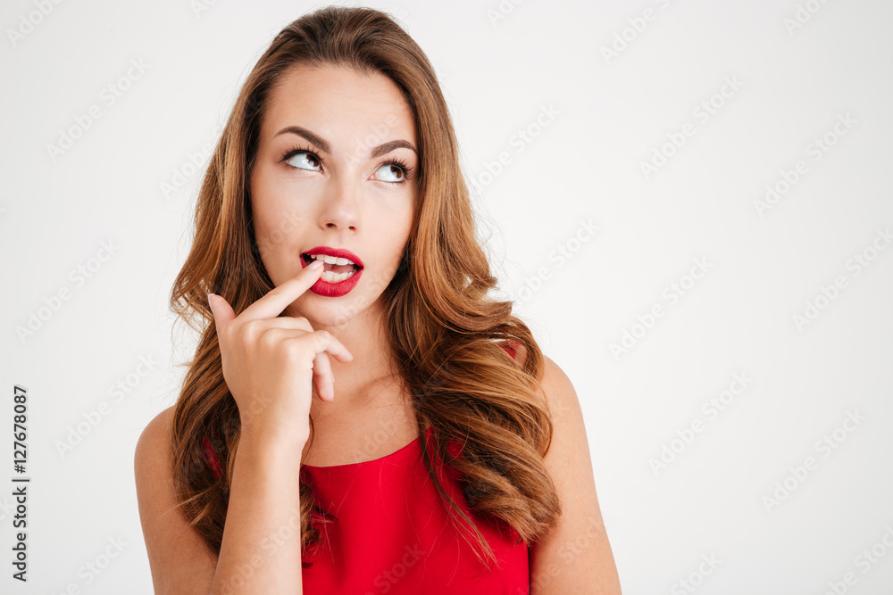 Beautiful wondered woman in red dress looking away Beautiful wondered woman in red dress looking away