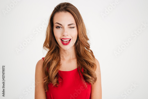 Smiling brunette woman winking and looking at camera