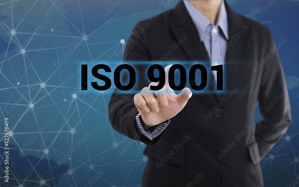 Businessman hand pressing button ISO 9001. sign on virtual screen. business concept. Businessman hand pressing button ISO 9001. sign on virtual screen. business concept.