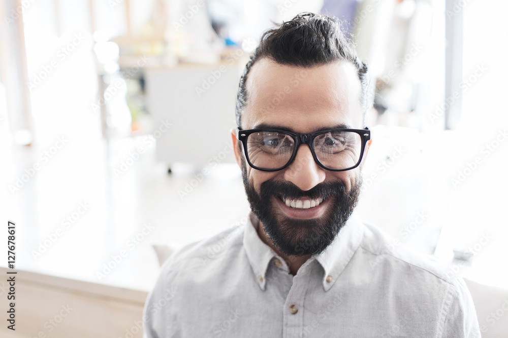 smiling man with eyeglasses and beard at office smiling man with eyeglasses and beard at office