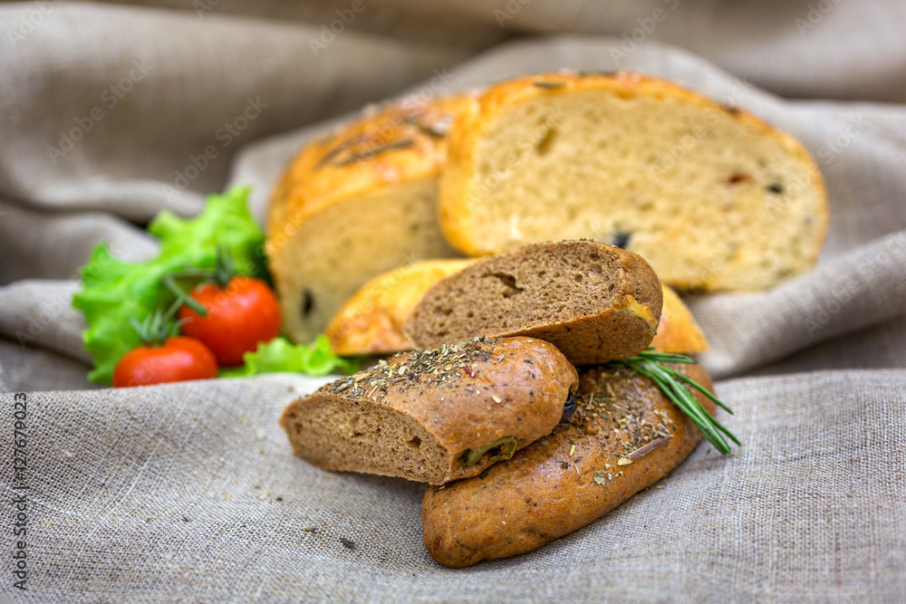 Fresh bread and vegetables on textiles Fresh bread and vegetables on textiles