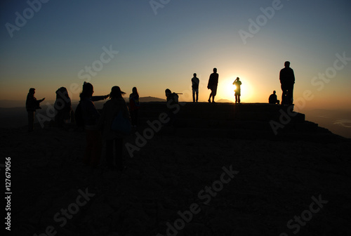 Silhouette of a group of people at sunset . © mustafavarlik