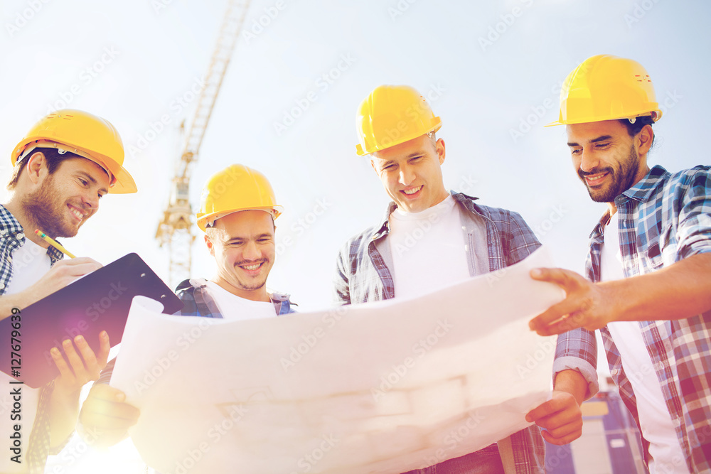 group of builders with tablet pc and blueprint group of builders with tablet pc and blueprint
