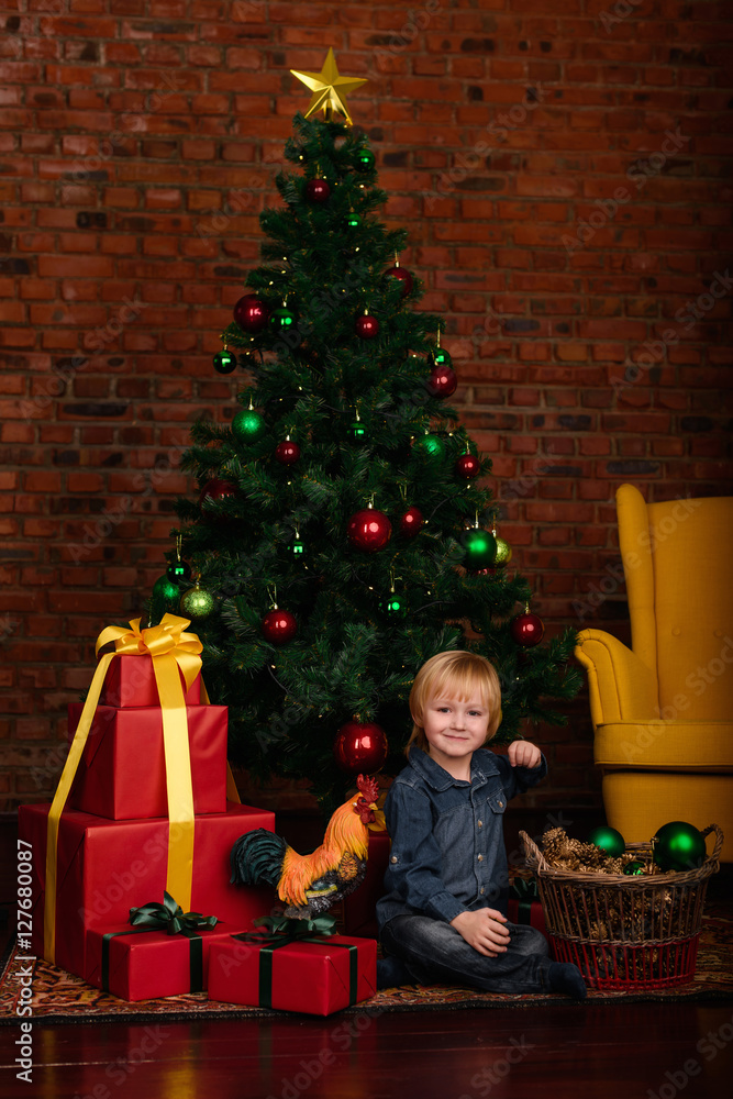 Cute little kid decorating Christmas tree Cute little kid decorating Christmas tree