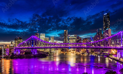Night time panorama of Brisbane city with purple lights on Story