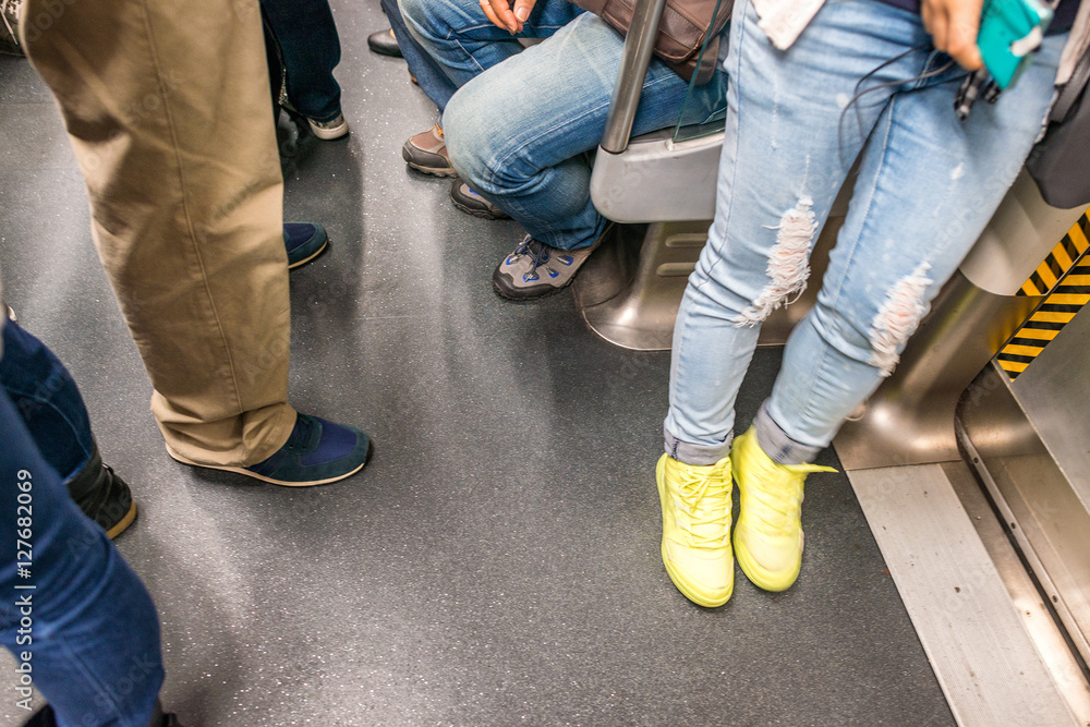People legs and feet inside subway train, blurred view People legs and feet inside subway train, blurred view