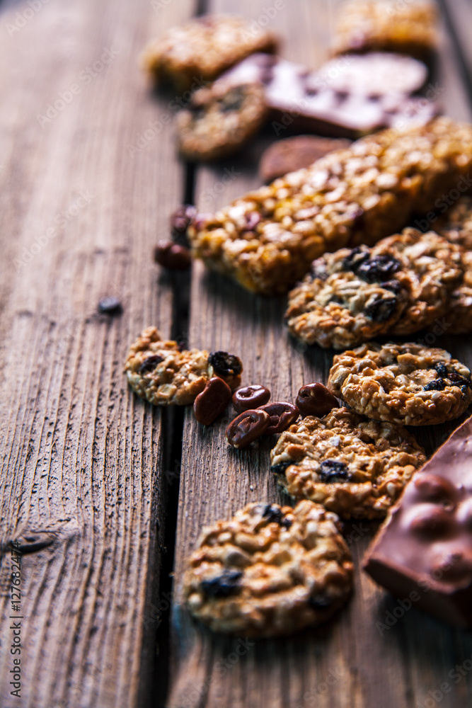 Set of sweets. Chocolate bars and granola on a wooden background with milk chocolates. Food, candy, snack Set of sweets. Chocolate bars and granola on a wooden background with milk chocolates. Food, candy, snack