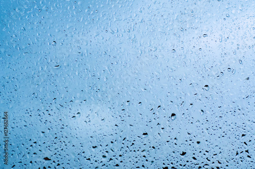 Rainy wet cold blue sky eco seasonal natural background with water drops