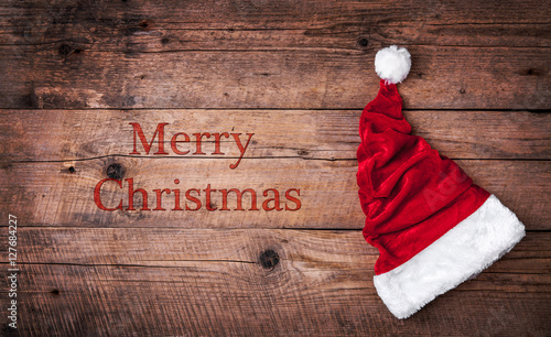 Santa red hat on wooden background, holiday Christmas