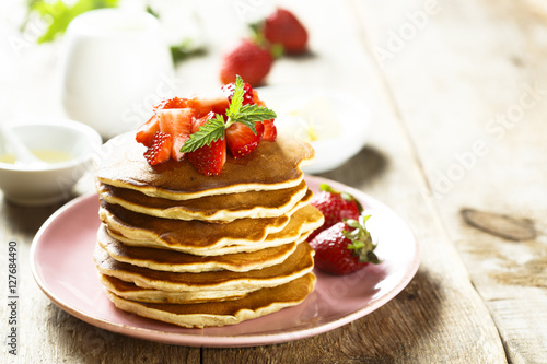 American pancakes with fresh strawberry and honey
