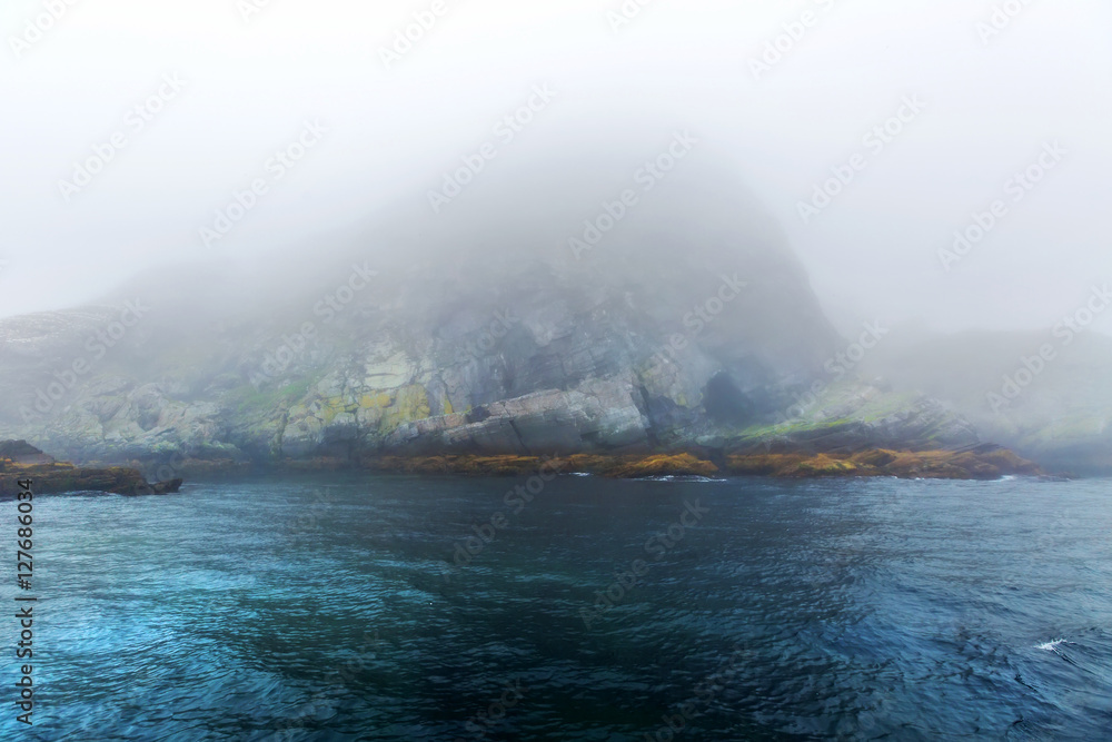 Majestic sea and  rocks in heavy fog