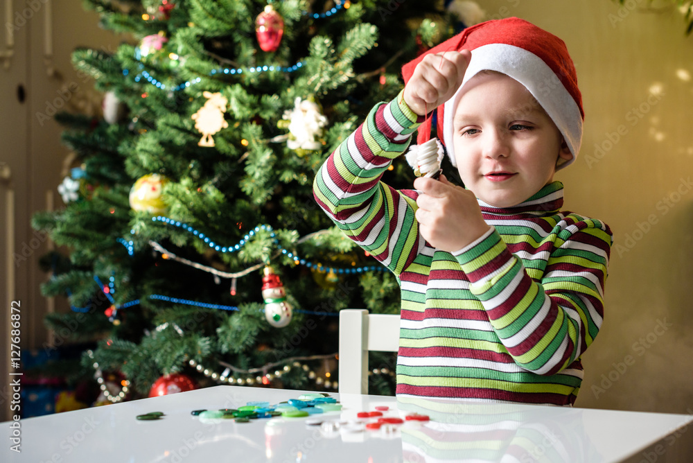 Kid child boy making by hands x-mas decorations Kid child boy making by hands x-mas decorations